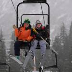Eaglecrest ski instructor Sarah Milks rides up an Eaglecrest chairlift with a fellow instructor, Saturday, Dec. 2, 2017. (Lance Nesbitt | For the Juneau Empire)