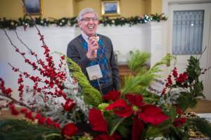 Lt. Gov. Byron Mallott laughs while sampling a cookie before the Governor&rsquo;s Open House on Tuesday, Dec. 5, 2017. (Michael Penn | Juneau Empire)