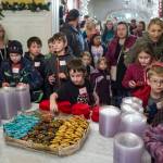 Children and adults alike look at all the cookies on display at the Governor&rsquo;s Open House on Tuesday, Dec. 5, 2017. (Michael Penn | Juneau Empire)