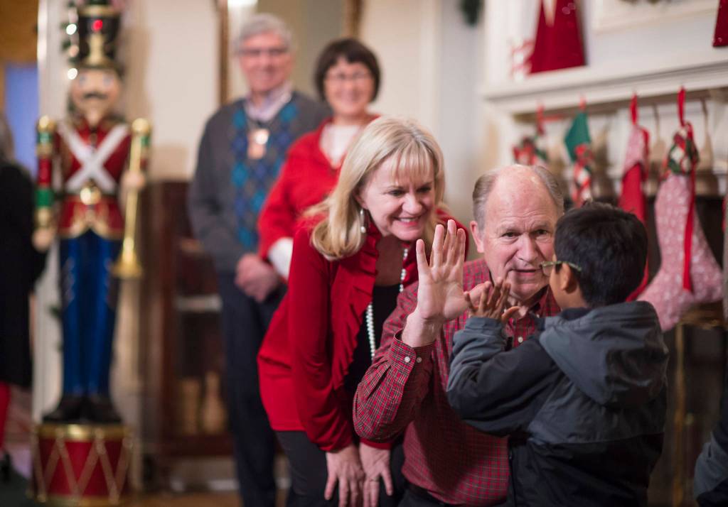 Gov. Bill Walker and his wife, Donna, gets a greeting from Henry Olmstead as he arrives for the Governor&rsquo;s Open House on Tuesday, Dec. 5, 2017. Lt. Gov. Byron Mallott and his wife, Toni, were also there for the annual opening. (Michael Penn | Juneau Empire)