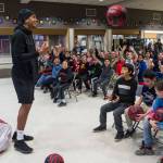 Professional basketball player Damen Bell-Holter, a Haida from Hydaburg, tosses basketballs to sixth-graders at Dzantik&rsquo;i Heeni Middle School at the end of his inspirational speech on Friday, Dec. 8, 2017. Each sixth-grader, 178 in total, received a free lineform designed basketball during the event. (Michael Penn | Juneau Empire)