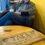 Guy Holt found a carved plaque on Sandy Beach 11 years ago and his been trying to find it owner ever since. Holt was photographed at Coppa on Thursday, Dec. 14, 2017. (Michael Penn | Juneau Empire)