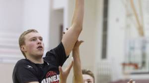 Erik Kelly shoots over teammate at Juneau-Douglas High School boys basketball practice at JDHS on Wednesday, Dec. 13, 2017.