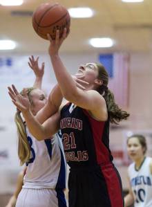 Juneau-Douglas&rsquo; Cassie Dzinich, right, is fouled by Sutherlin&rsquo;s Taylor Moser during their Capital City Classic Basketball Tournament game at JDHS on Thursday, Dec. 28, 2017. (Michael Penn | Juneau Empire)