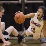 Juneau-Douglas&rsquo; Alyxn Bohulano, right, dives to the ball against Chugiak&rsquo;s Aliza Schwartz during their Capital City Classic Basketball Tournament game at JDHS on Saturday, Dec. 30, 2017. (Michael Penn | Juneau Empire)