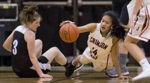 Juneau-Douglas&rsquo; Alyxn Bohulano, right, dives to the ball against Chugiak&rsquo;s Aliza Schwartz during their Capital City Classic Basketball Tournament game at JDHS on Saturday, Dec. 30, 2017. (Michael Penn | Juneau Empire)