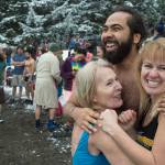 Devin Drones, Diane Bean, left, and Susan James huddle for warmth as they wait the countdown for the annual Polar Bear Dip at Auke Recreation beach on Monday, Jan. 1, 2018. (Michael Penn | Juneau Empire)