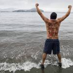 Marvin Pena steels himself for the annual Polar Bear Dip at Auke Recreation beach on Monday, Jan. 1, 2018. (Michael Penn | Juneau Empire)