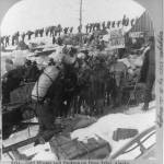 Library of Congress, 3b12801; KLGO Digital Library &ldquo;Gold Miners and Packers on Dyea Trail, Alaska&rdquo; looking west, most likely taken winter of 1898. Photographer: B. L. Singley (Keystone View Company) This photograph shows the Gasoline Tramway Company sign amid stampeders, horses, and outfits. The gasoline powered tramway was introduced by mid-April 1898. It was described as &ldquo;simply a pulley drum and gasoline engine at the summit of the pass, and enough rope to reach the bottom. Sleds were hitched onto the rope, which was wound around the drum and it pulled them to the top.&rdquo; In the background is the line of stampeders hiking on the Golden Stairs