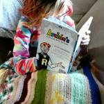 A. Darden curls up under an afghan as the temperature outside drops to the low twenties. She&rsquo;s transported to sunny Riverdale as she colors. Photo by Tara Neilson