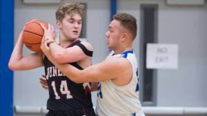 Juneau-Douglas&rsquo; Kasey Watts is fouled by Thunder Mountain&rsquo;s Vaipuna Toutaiolepo during their game at TMHS on Friday, Jan. 5. The Crimson Bears and Falcons both lost on Thursday in the Alaska Prep Shootout and Joe T. Classic, respectively. (Michael Penn | Juneau Empire File)