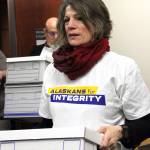 Joelle Hall carries one of nine boxes containing more than 45,000 signatures into the Alaska Division of Elections office in Anchorage, Friday, Jan. 12, 2018. Elections workers will have to verify the signatures before the measure is approved for the ballot. (Mark Thiessen | The Associated Press)
