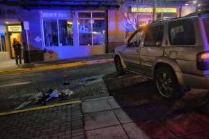 An SUV sits on Seward Street with a concrete planter at the corner of Seward Street and Second Street on Thursday night. The driver and sole passenger were taken to the hospital for injuries that were not life-threatening. (Courtesy photo | Jessie Herman-Haywood)