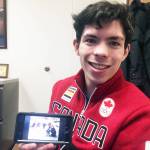 Keegan Messing shows off a childhood photo of his family on ice skates during his trip to Juneau Friday. (Nolin Ainsworth | Juneau Empire)