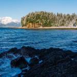 Splashing waves from the tide coming in. A beach cliff face is in the background. (Gabe Donohoe | For the Juneau Empire)