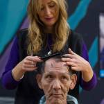 Greg Ogawa receives a free haircut by Abra James of Agape Salon during the Juneau Coalition on Housing & Homelessness&rsquo; 7th annual Project Homeless Connect in the Zach Gordon Youth Center on Wednesday, Jan. 24, 2018. (Michael Penn | Juneau Empire)