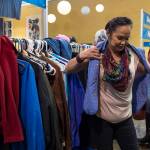 Veronica Shortcakes tries on clothing during the Juneau Coalition on Housing & Homelessness&rsquo; 7th annual Project Homeless Connect in the Juneau Arts & Culture Center on Wednesday, Jan. 24, 2018. (Michael Penn | Juneau Empire)