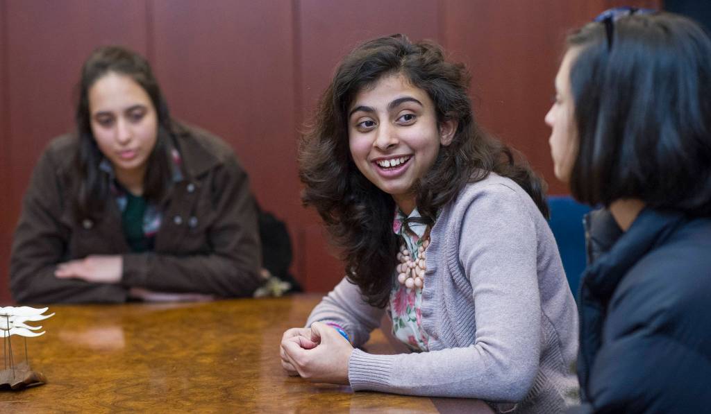 Shanzila Ahmad discusses her exchange experience while Ceren Gokpinar and Haifa Alsafadi listen. Michael Penn | Capital City Weekly.