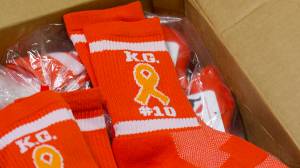 Juneau-Douglas and Thunder Mountain High School players will wear custom-made orange socks in remembrance of Kevin Guimmayen for Saturday&rsquo;s game at JDHS. (Nolin Ainsworth | Juneau Empire)