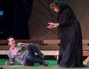 Patricia Hull, as the witch, bullies Zebadiah Bodine, as the Baker, into taking Little Red Riding Hood&rsquo;s red cape to undo a spell during rehearsal of Juneau-Douglas High School&rsquo;s production of &ldquo;Into the Woods&rdquo; at JDHS on Wednesday, Jan. 31, 2018.