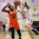 Juneau-Douglas&rsquo; Cassie Dzinich, right, drives to the basket against West&rsquo;s Nyeniea John during their game on Friday, Feb. 2, 2018. (Michael Penn | Juneau Empire)