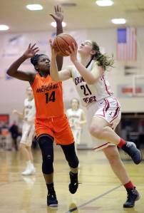 Juneau-Douglas&rsquo; Cassie Dzinich, right, drives to the basket against West&rsquo;s Nyeniea John during their game on Friday, Feb. 2, 2018. (Michael Penn | Juneau Empire)