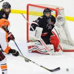 Juneau-Douglas High School goalie Cody Mitchell prepares for a shot by West Anchorage&rsquo;s Revy Mack in the first period of First National Cup state hockey championships Thursday in Wasilla. (Michael Dinneen | For the Juneau Empire) Juneau goalie Cody Mitchell prepares for a shot by West&rsquo;s Revy Mack in the first period. (Michael Dinneen | For the Juneau Empire)