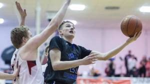 Thunder Mountain High School&rsquo;s Luke Clark tries to score around Juneau-Douglas High School&rsquo;s Erik Kelly at JDHS on Friday, Feb. 2, 2018. The Falcons, who have played the last 11 games on the road, host Mt. Edgecumbe High School on Friday at 8 p.m. and Saturday at 6 p.m. (Michael Penn | Juneau Empire File)