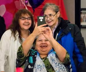 Jacqui Cropley takes a selfie with Jeannie Lee, left, and Vivian Hotch at the Tlingit-Haida Community Council&rsquo;s Elders Valentine&rsquo;s Day Dance on Thursday. (Richard McGrail | Juneau Empire)