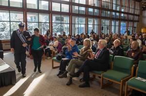 Alaska Native Sisterhood President Kevin Allen, left, escorts Keynote speaker Joaqlin Estus to the podium during the Elizabeth Peratrovich Day Celebration at the University of Alaska Southeast on Friday, Feb. 16, 2018. (Michael Penn | Juneau Empire)
