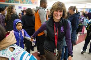 In this Aug. 16, 2017 photo, Principal Michelle Byer helps first-grader Laila George through the crowd during the first day of the school at Riverbend Elementary School. (Michael Penn | Juneau Empire File)