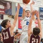 Thunder Mountain&rsquo;s Luke Clark shoots over Ketchikan&rsquo;s Cody Kemble, left, and Kristian Pihl at TMHS on Friday, Feb. 23, 2018. Ketchikan won 57-31. (Michael Penn | Juneau Empire)