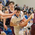 Thunder Mountain&rsquo;s Bryson Echiverri, center, is heavily guarded by Ketchikan&rsquo;s Kyle Smith, left, Kristian Pihl, background, and Cody Kemble at TMHS on Friday, Feb. 23, 2018. Ketchikan won 57-31. (Michael Penn | Juneau Empire)