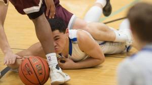 Thunder Mountain&rsquo;s Roy Tupou dives for a loose ball against Ketchikan at TMHS on Friday, Feb. 23, 2018. TMHS lost 57-31 Friday but won 59-54 Saturday. (Michael Penn | Juneau Empire)