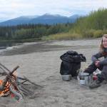 Mary Catharine Martin cooks dinner along the Nisutlin River in the Yukon in September 2014. Photo by Bjorn Dihle
