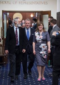 U.S. Sen. Dan Sullivan, R-Alaska, center, is escorted out of the House of Representatives by Rep. Paul Seaton, R-Homer, left, and Sen. Mia Costello, R-Anchorage, after his annual speech to a joint session of the Alaska Legislature at the Capitol on Monday, Feb. 26, 2018. (Michael Penn | Juneau Empire)