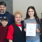 Thunder Mountain High School senior Maxie Saceda-Hurt, second from right, with her family (L to R) Frank Hurt, Pedrin Saceda-Hurt, Gethsemane Saceda and Nickie Saceda-Hurt on Sunday after signing a national letter of intent to play softball at Simpson College next season. (Nolin Ainsworth | Juneau Empire)