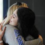 Maxie Saceda-Hurt, right, hugs Thunder Mountain High School softball coach Brittany Gladsjo on Sunday at TMHS after signing a national letter of intent to play at Simpson College next season. (Nolin Ainsworth | Juneau Empire)