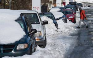 Parked vehicles and piles of snow line 11th Street on Thursday, March 1, 2018. February was cold and the forecast for March is for more of the same. (Michael Penn | Juneau Empire)