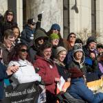 Lizette Stiehr, executive director for the Alaska Association on Developmental Disabilities, holds up a loud speaker microphone during singing at Key Coalition Rally at the Capitol on Friday, March 2, 2018. The Key Coalition of Alaska educates legislators about the importance of sustaining community-based services for people with disabilities and Intellectual and Developmental Disabilities. (Michael Penn | Juneau Empire)
