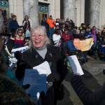 Lizette Stiehr, executive director for the Alaska Association on Developmental Disabilities, holds up a loud speaker microphone during singing at Key Coalition Rally at the Capitol on Friday, March 2, 2018. The Key Coalition of Alaska educates legislators about the importance of sustaining community-based services for people with disabilities and Intellectual and Developmental Disabilities. (Michael Penn | Juneau Empire)