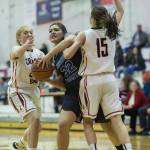 Thunder Mountain&rsquo;s Nina Fenumiai, center, drives against Juneau-Douglas&rsquo; Jenae Pusich, right, and Morgan Balovich at JDHS on Friday, March 3, 2018. JDHS won 53-33. (Michael Penn | Juneau Empire)