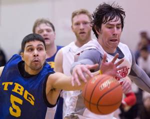In this March 23, 2017 photo, Juneau James Gang&rsquo;s Billy Ehlers chases a loose ball against Hoonah&rsquo;s Donald Dybdahl in their C Bracket game in the Lions Club&rsquo;s Gold Medal Basketball Tournament at Juneau-Douglas High School. (Michael Penn | Juneau Empire File)