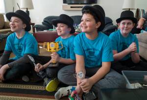 Stig Cunningham, 12, left, his brother, Kajson, 10, Sione Tupou, 11, and Aiden Pietan, 12, right, talk Friday, March 2, 2018, about winning the regional award for their project at the First Lego League in Anchorage earlier this year. Working under the team name of Happy Dave, the students have been researching and working with a company to develop a spray to break down dog feces. (Michael Penn | Juneau Empire)