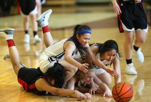 Thunder Mountain freshman Neal Garcia, top left, and sophmore Lezille Sagrado, top right, Juneau-Douglas junior Alyxn Bohulano, bottom left, and sophomore Sadie Tuckwood fight for a loose ball Thursday during the Region V 4A tournament. For more Regions coverage, see B1. Dustin Safranek | Ketchikan Daily News