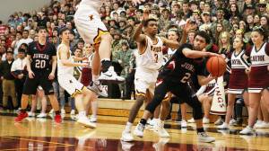 Juneau-Douglas&rsquo; Gammy Reyes, right, looks for an open pass around Ketchikan&rsquo;s Jake Taylor, left, and Marcus Lee on Friday during the Region V 4A boys tournament. Reyes scored 10 points in a 61-51 JDHS win. (Dustin Safranek | Ketchikan Daily News)