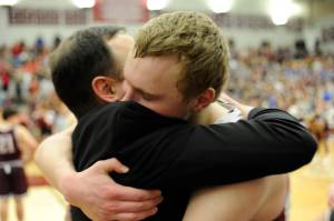 Juneau-Douglas&rsquo; Erik Kelly hugs JDHS head coach Robert Casperson at the conclusion of the Region V 4A boys championship game. JDHS defeated Kayhi 58-53 Saturday night at Ketchikan High School. Nolin Ainsworth | Juneau Empire