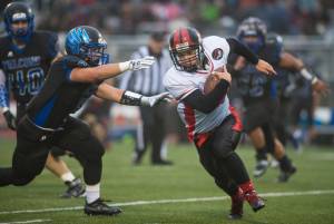 In this Sept. 1, 2017 photo, Thunder Mountain&rsquo;s Roy Tupou, left, chases Juneau-Douglas&rsquo; Liam Van Sickle at TMHS. TMHS won 10-7 in overtime. (Michael Penn | Juneau Empire File)