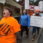 Juneau-Douglas High School student Theo Houck, left, leads a cheer as student participate in the National School Walk Out on Wednesday, March 14, 2018. The students marched from school to the Capitol in support of the 17 victims of the Marjory Stoneman Douglas High School shooting one month ago. (Michael Penn | Juneau Empire)