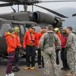 Juneau Mountain Rescue searchers undergo a safety briefing on the tarmac prior to takeoff. (Courtesy photo | Ben Huff)
